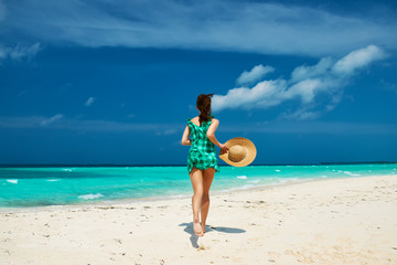 Fototapeta na wymiar Woman in green dress at beach
