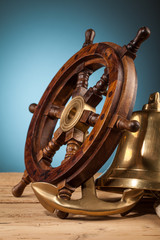 maritime adventure  anchor bell and old wooden steering wheel
