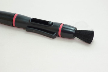 Pocket lens pen and brush for cleaning camera isolated on white