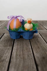 Frühstücksei  mit kleiner Ente in einem Eierkarton/Nest