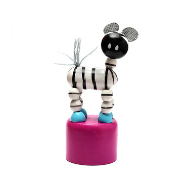 small wooden toy zebra on a pedestal