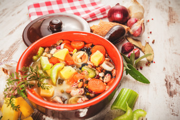 Rural vegetarian broth soup with colorful vegetables and rustic