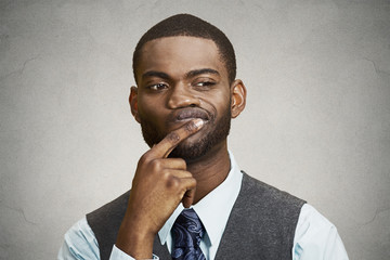 Man skeptic, confused, thinking isolated on grey wall background