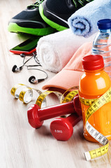 Fitness concept with dumbbells, fruits juice and sportswear © Symbiot