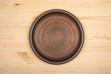 Ceramic bowl on wood background. Top view