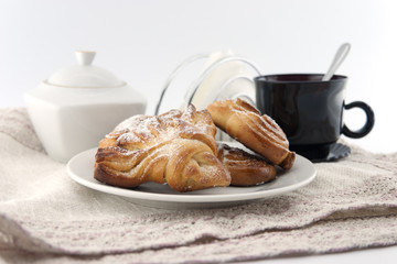 Freshly baked bun with a cup of coffee.