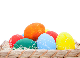 Colorful easter eggs in basket. All on white background
