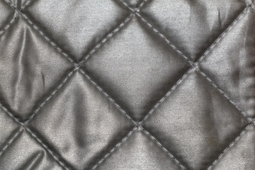 The texture of shiny fabric stitched squares