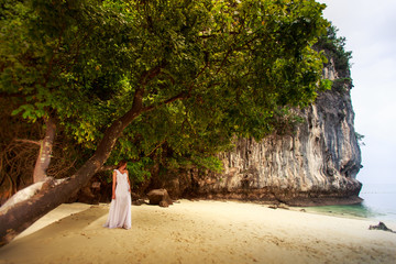 bride demonstrates herself at sand beach