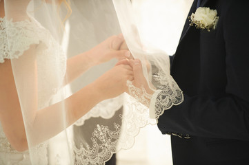 Bride and groom's hands at wedding ceremony.