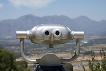 High power viewing machine and a mountain backdrop