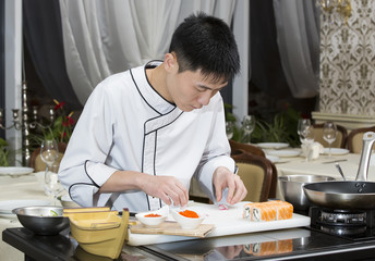 Japanese chef preparing a meal in a restaurant