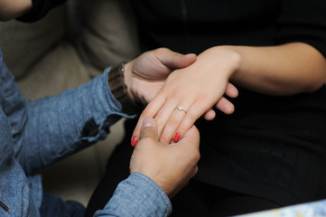 Fototapeta premium just engaged couple holding hands at restaurant
