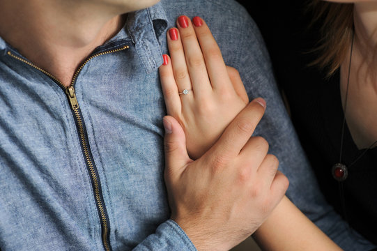 just engaged couple holding hands at restaurant