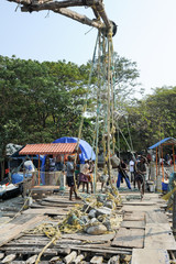 Fishermen operate a Chinese fishing net