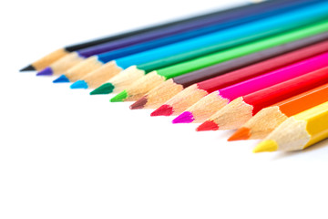 Colored pencils on an isolated background. Focus on the red 