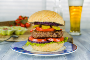 Homemade beef burger and a glass of beer