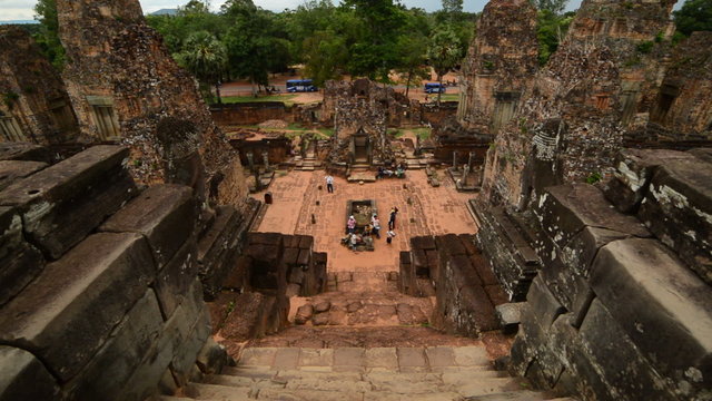 Zoom Out - Looking Down Temple Steps as Tourists walk around the Altar - Angkor Wat, Cambodia