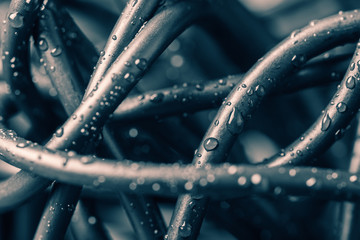 Tangled wires with water drops, abstract background