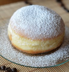 Donut with powdered sugar on the brown plate