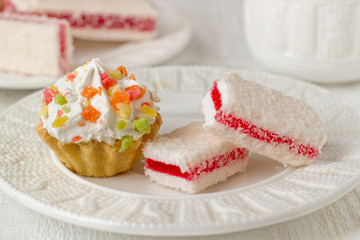 Cupcakes and coconut raspberry dessert with tea