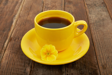 Cup of coffee with spices and flower on a wooden table backgroun