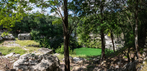 Fototapeta na wymiar Panorama of Sacrifice Cenote at Chichen Itza ruins. Mayan Cultur