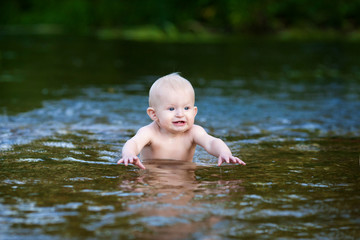 Fototapeta premium The child is bathing in the river