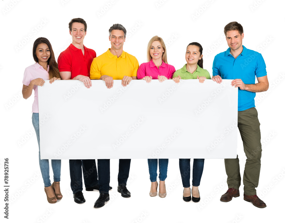 Wall mural multiethnic group of friends showing blank billboard