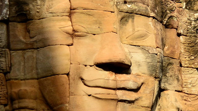 Zoom out -  Stone Carving of Buddha God on Temple Wall  - Angkor Wat, Cambodia