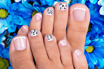 Beautiful woman's nails of legs with beautiful french manicure