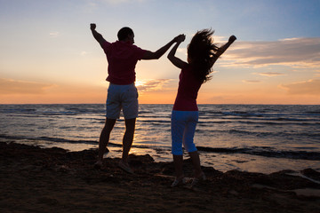 Couple Enjoying Ocean View At Beach During Sunset