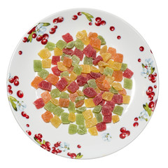 Candied fruits on porcelain plate, top view