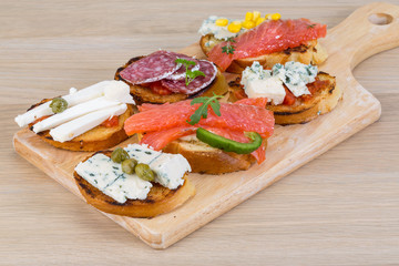 Tapas with cheese, salami and salmon