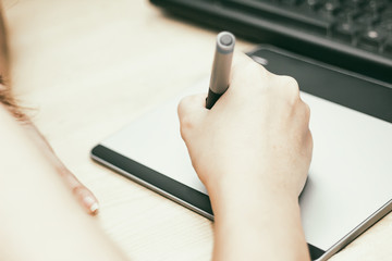 Retro image of female hand of a designer drawing