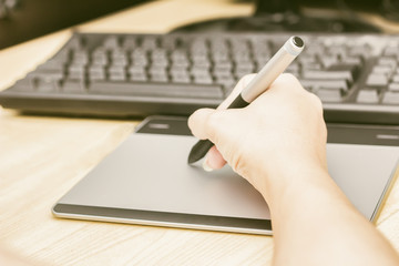 Retro image of female hand of a designer drawing