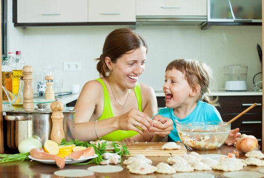  mother with her daughter makes  fish meatballs in home