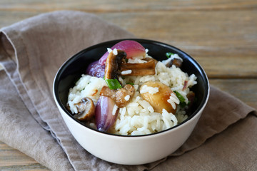 Rice with mushrooms and onions in a bowl