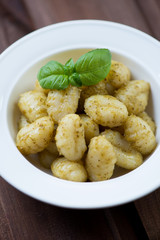 Close-up of italian gnocchi with basil pesto, selective focus