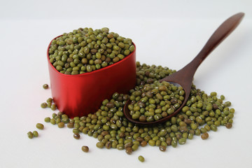 Mung Bean in red bowl and wooden spoon
