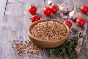 Buckwheat in a bowl with tomato, garlic and thyme
