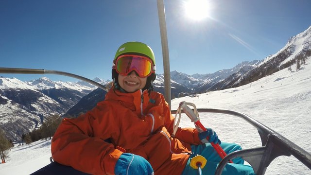 Skiing - young girl on ski lift