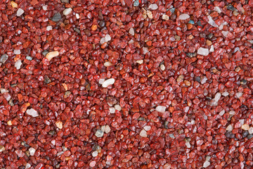 Red stone texture close-up horizontal background.