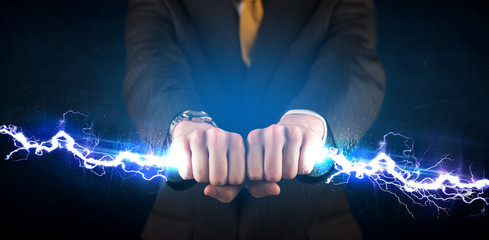 Business man holding electricity light bolt in his hands