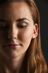 Fototapeta na wymiar Studio Portrait Of Young Woman Crying