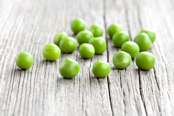 Green peas on wooden background
