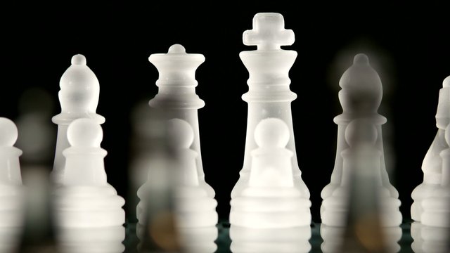 4K. Glass chess dynamic change of focus. Hand transposes pawns