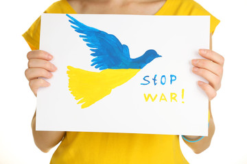 Woman holding paper dove with painted Ukraine flag, isolated