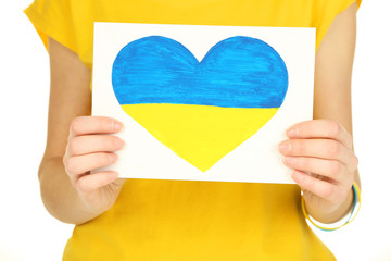 Hands holding paper heart with painted Ukraine flag, isolated