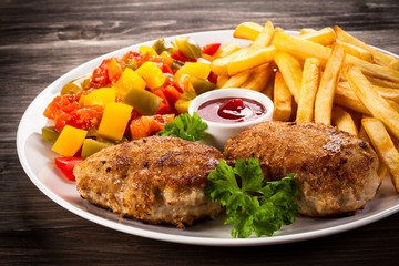 Fried chops, French fries and vegetable salad